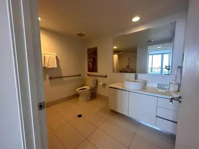 a bathroom with a sink and a toilet and a mirror at Miami Beach, Full Kitchen & Style -A in Hallandale Beach