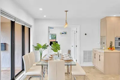 a kitchen and dining room with a table and chairs at Tropical Oasis With heated pool 10 mins airport & 5 mins Beach in Hollywood