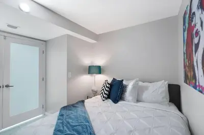 a white bedroom with a bed and a window at Funkin' Fabulous! Water & City Views! 4BR in Miami