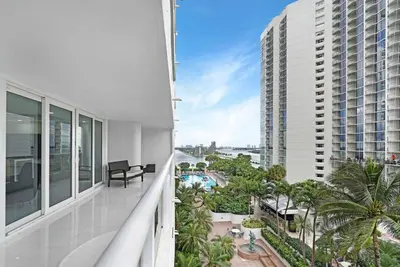 an apartment balcony with a view of a building at Funkin' Fabulous! Water & City Views! 4BR in Miami