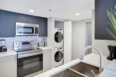 a kitchen with a washer and dryer at Stay in Love! Miami Skyline Views, Renovated in Miami