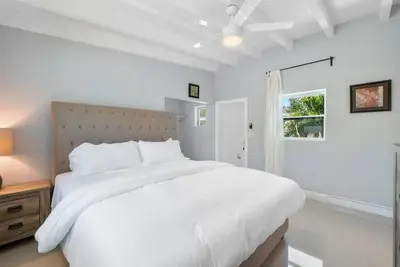 a white bedroom with a large bed and a window at Together but with Privacy 3 Units and Private Pool in Fort Lauderdale