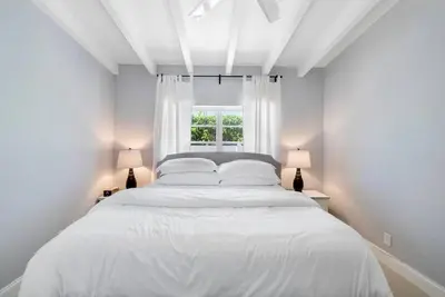a white bed in a white room with a window at Together but with Privacy 3 Units and Private Pool in Fort Lauderdale
