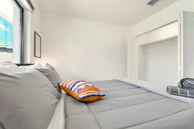 a bed with a pillow on it in a room at Stunning 3-Bedroom Duplex with Free Parking in Miami