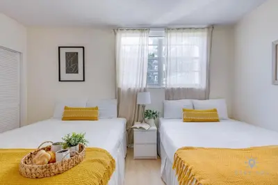 a bedroom with two beds and a basket of fruit at Paradise Retreat, Near Beach, Casino, and More in Hollywood