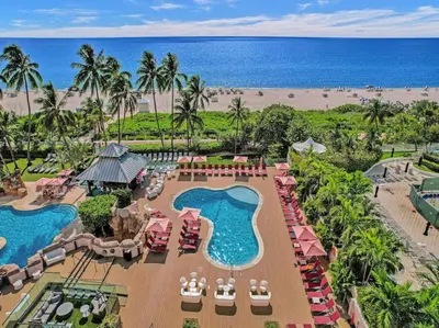 an aerial view of a resort with a pool and the beach at Modern Ocean View Condo Beach Service Unit 1206 in Miami Beach