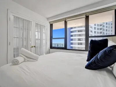 a bedroom with a large bed with a large window at Cozy 2 Bedroom Ocean View Beach Service 707 in Miami Beach