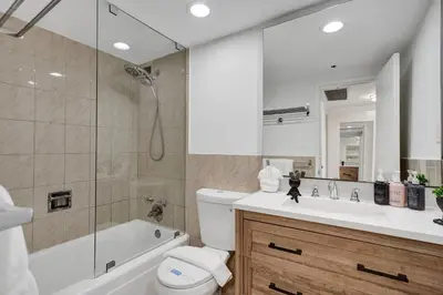 a bathroom with a tub and a toilet and a sink at Ocean View condo w beach service 411 in Miami Beach