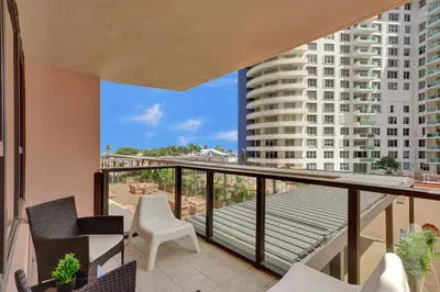 a balcony with chairs and a view of a building at Ocean View condo w beach service 411 in Miami Beach