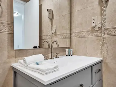 a bathroom with a sink and a mirror at Ocean View Condo Beach Service 1504 in Miami Beach