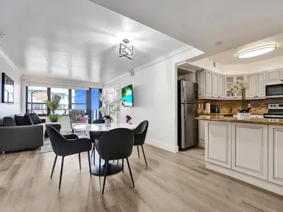 a kitchen and living room with a table and chairs at Ocean View Condo Beach Service 1504 in Miami Beach