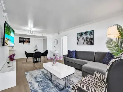 a living room with a couch and a table at Ocean View Condo Beach Service 1504 in Miami Beach