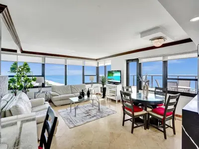 a living room with a couch and a table at Huge Terrace Oceanfront Condo Beach Service 1502 in Miami Beach