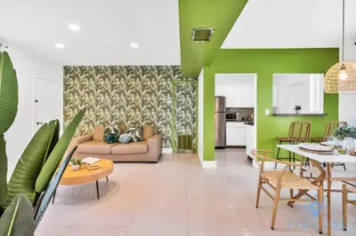 a living room with green walls and a couch at Free Parking - Bay View - Pool -Step To Beach in Hollywood