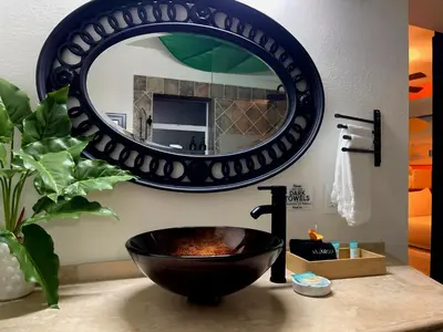 a bathroom with a black bowl sink and a mirror at Fun Getaway: Hot Tub, Tiki Bar, Arcade Room in Hollywood