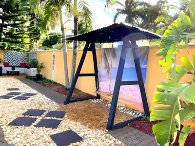 a play structure in a yard with a roof at Fun Getaway: Hot Tub, Tiki Bar, Arcade Room in Hollywood