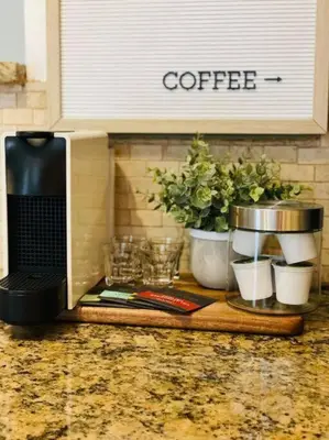 a kitchen counter with a coffee maker and potted plants at Tropical Oasis House Private Pool Family Yard in Fort Lauderdale