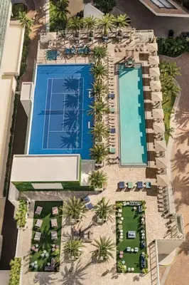 an overhead view of a resort pool with palm trees at 2BR & 2BA Corner Suite Ocean Views at Hyde Beach House in Hollywood