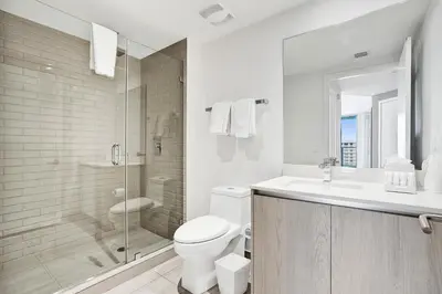 a bathroom with a toilet and a shower and a sink at 2BR & 2BA Corner Suite Ocean Views at Hyde Beach House in Hollywood