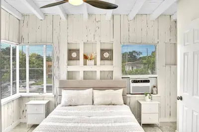 a bedroom with a bed and a ceiling fan at New Year and Holiday Charming Miami Riverfront Stay! in Miami