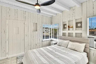 a bedroom with a bed and a ceiling fan at New Year and Holiday Charming Miami Riverfront Stay! in Miami