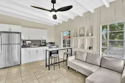a living room with a couch and a ceiling fan at New Year and Holiday Charming Miami Riverfront Stay! in Miami