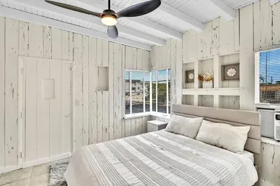 a bedroom with a bed and a ceiling fan at New Year and Holiday Charming Miami Riverfront Stay! in Miami