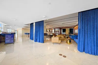 a lobby with blue curtains in a building at Marenas LATERAL ocean view daily refresh not included Fees collected at arrival in Sunny Isles Beach