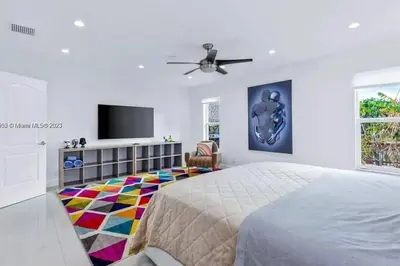 a bedroom with a bed and a colorful carpet at Ocean House in Dania Beach