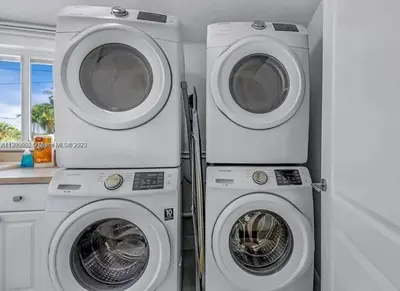 two washing machines and a washer and dryer in a room at Ocean House in Dania Beach
