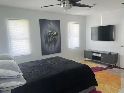a bedroom with a bed and a flat screen tv at Ocean House in Dania Beach