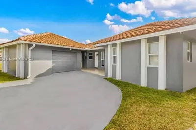 a large house with a driveway at Ocean House in Dania Beach