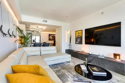 a living room with a white couch and a tv at High-End Miami Condo with City and Bay Views!!! in Miami