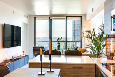a living room with a view of the city at High-End Miami Condo with City and Bay Views!!! in Miami