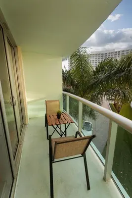 a balcony with a table and a chair on it at Tides Condominiums in Hollywood