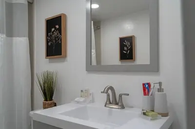 a white bathroom with a sink and a mirror at Tides Condominiums in Hollywood