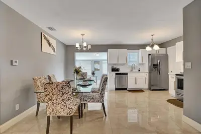 a kitchen and dining room with a table and chairs at Luxury 3bd/2ba near Beach & Las Olas in Fort Lauderdale