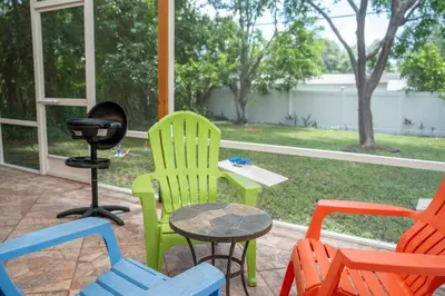 a group of chairs and a grill in a yard at 5 min to airport and 15 min to beach! in Fort Lauderdale