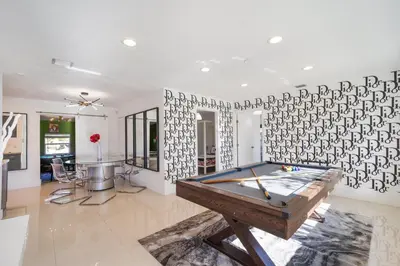 a ping pong table in a living room with a wall at Dior Lake Front Villa With Infinity Pool in Miami Gardens
