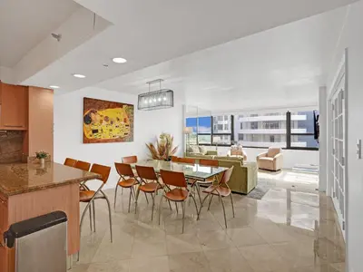 a kitchen and dining room with a table and chairs at Beach Resort condo 921 in Miami Beach