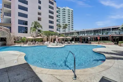 a large swimming pool in front of a building at Beachfront Ocean View Condo Beach Service 520 in Miami Beach
