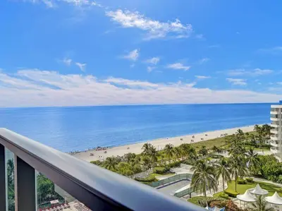 a view of the beach from the balcony of a resort at Beachfront Condo w Beach Service 1207 in Miami Beach