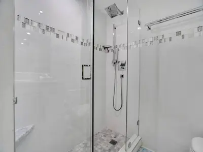 a bathroom with a shower with a glass door at Beachfront Condo w Beach Service 1207 in Miami Beach