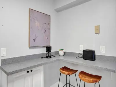 a kitchen with a counter with two stools at High Floor Beachfront Condo Beach Service 1509 in Miami Beach