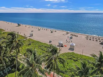 an aerial view of a beach with palm trees and the ocean at Full ocean view Huge private terrace 1002 in Miami Beach