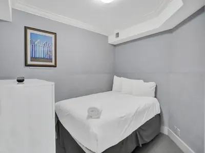 a white bed in a white room with a picture at Amazing 3BD Ocean View Condo Beach Service 715 in Miami Beach