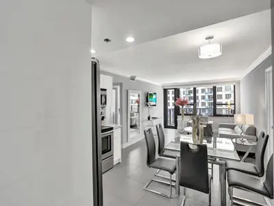 a kitchen and dining room with a table and chairs at Amazing 3BD Ocean View Condo Beach Service 715 in Miami Beach