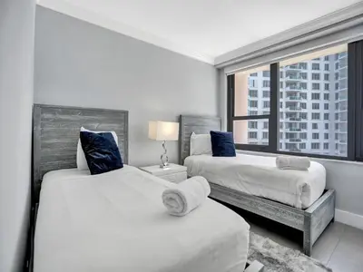 two beds in a room with a window at Amazing 3BD Ocean View Condo Beach Service 715 in Miami Beach