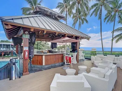 a bar with white couches in front of a pool at Cozy Ocean View Condo Beach Service 1015 in Miami Beach