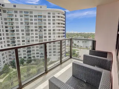 a balcony with chairs and a view of a building at Perfect Ocean View Condo Beach Service 1109 in Miami Beach